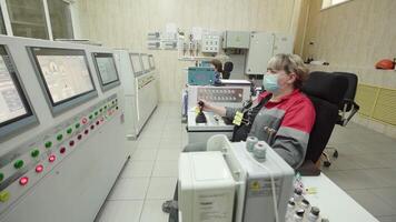 An Operator is Actively Engaged in Work Within a Control Room Environment to Ensure Efficiency. Stock Clip video