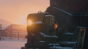 Heavy mining machinery is moving on winter day. Stock footage. Mining operations with moving machinery in winter. Sun's rays shine on heavy mining equipment in winter video