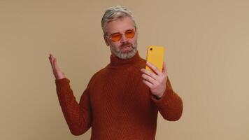 Middle-aged man traveler blogger taking selfie on smartphone, communicating call online stream video