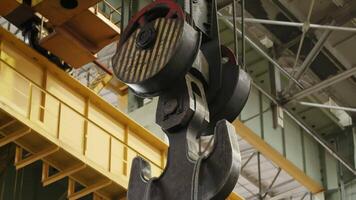 An Industrial Crane Hook and Pulley System in a Warehouse Setting for Material Handling. Stock Clip video