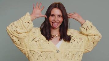 Funny joyful woman making playful silly facial expressions, grimacing, fooling around showing tongue video