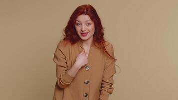 Woman pointing to camera and looking with playful happy expression, making choice, showing direction video