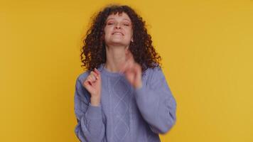 Woman pointing to camera and looking with playful happy expression, making choice, showing direction video