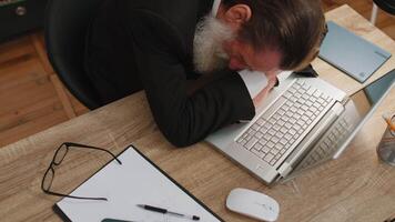 Bored tired sleepy business man falling asleep after routine work on laptop computer at office desk video