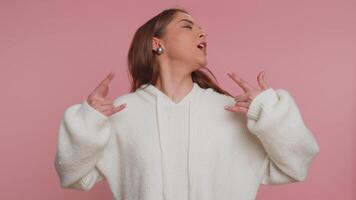 Overjoyed happy woman showing rock n roll gesture by hands, cool sign, shouting yeah with crazy face video