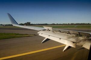 Aircraft Wing with Extended Spoilers A Close Up View on the Runway photo