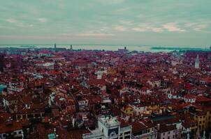 Panoramic View Red Rooftops and Historic Features in Venice photo