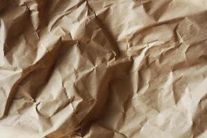 Old crumpled brown paper texture photo
