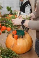 Creating a floral composition in a pumpkin. Making decor with your own hands. photo
