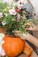 Creating a floral composition in a pumpkin. Making decor with your own hands. photo