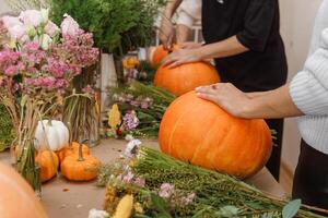Creating a floral composition in a pumpkin. Making decor with your own hands. photo