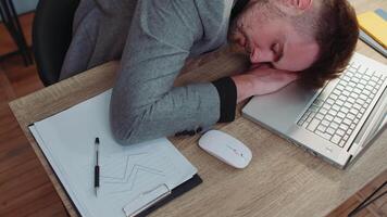 Bored tired sleepy business man falling asleep after routine work on laptop computer at office desk video