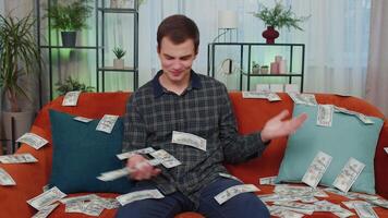 Successful happy rich business man counting money cheering up with high profits, lottery game win video