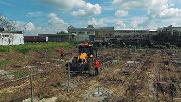 Heavy equipment on construction site. Aerial flight over new constructions site development while heavy machinery and construction workers working with power tools video