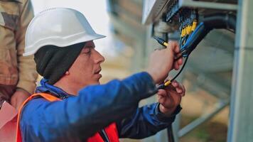 Worker checking solar cell system. Engineer checks the electrical box in the solar photovoltaic area video