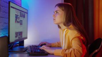 Woman using computer at home. Woman sitting at the table at home, working on computer video