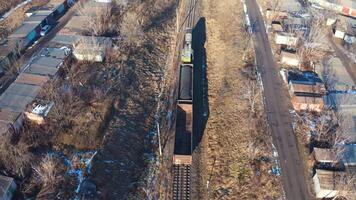 Train on railroad from above. Aerial view of train on railway track through countryside video