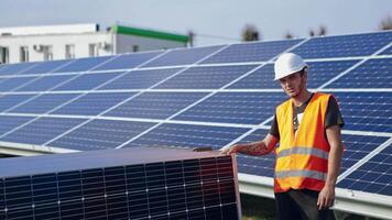 Technician installing solar panels. Installing alternative energy photovoltaic solar panels video