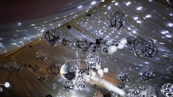 Rotating sparkling disco ball. Mirror disco ball reflecting lights background video