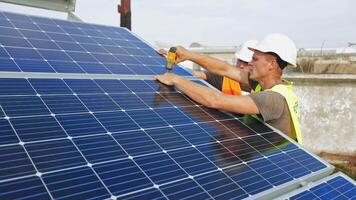 Technician installing solar cell. Technicians mounting photovoltaic solar panels video
