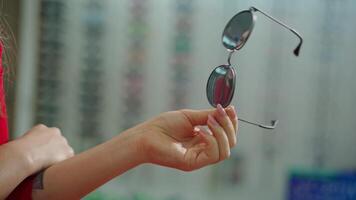 Woman at optician with glasses. video