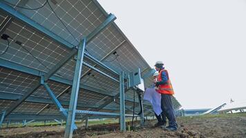 Solar power plant with two engineers. video