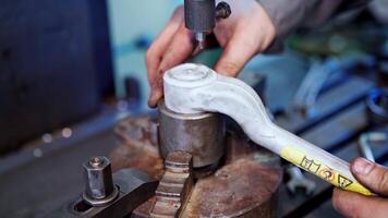 Man working in industry factory. Engineer with handtool doing his work by huge industrial machine in factory video