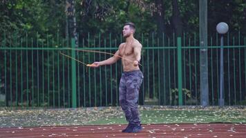 Man exercising with jumping rope. Yong handsome fit man jumping rope on stadium video