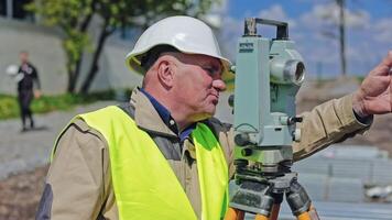 Survey engineer at construction site. Construction engineers supervising progress of construction project video