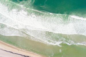 top-down view of beach with vibrant turquoise water, concept of Drone view tranquility photo