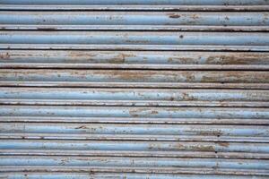 old metal shutter, rusted and weathered paint. Textured background photo