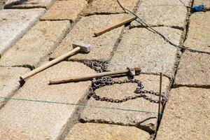 tools for stone construction with granite ashlars, masonry concept background photo