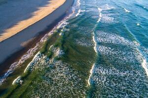 view of the shore of a beach at sunrise, aerial photography with drone at sunset. Summer concept background photo