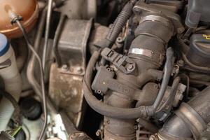 detail of the engine of a diesel car in a garage for inspection photo