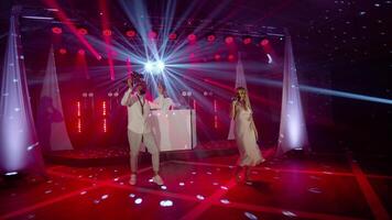 Musical band group of vocalist, saxophonist, DJ playing song, performing on musician concert stage video