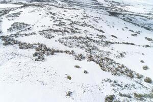 view of hills in a snowy landscape in winter, snowy mountain scenery in winter.Drone aerial view Nature in wintertime background photo