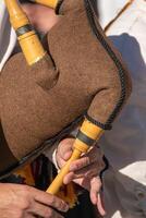 detail of the hands of a bagpipe player playing a traditional bagpipe from Portugal, background concept folk music photo