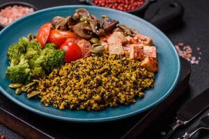 Quinoa bowl with tofu, steamed vegetables, grains, seeds and spices photo