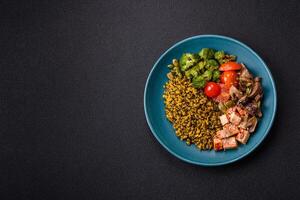 Quinoa bowl with tofu, steamed vegetables, grains, seeds and spices photo