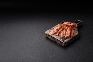 Bacon sliced, grilled with salt and spices photo