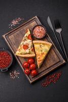 Delicious quiche with broccoli, cheese, chicken, spices and herbs photo