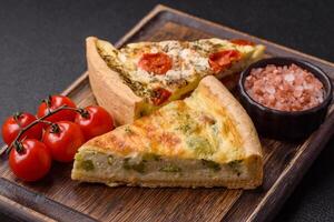 Delicious quiche with broccoli, cheese, chicken, spices and herbs photo