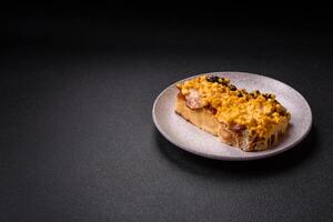 Sandwich with brioche, meat, melted cheese, corn, salt, spices and herbs photo