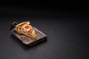 Delicious crispy quiche cut into slices with cheese, broccoli, tomatoes photo