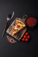Delicious crispy quiche cut into slices with cheese, broccoli, tomatoes photo