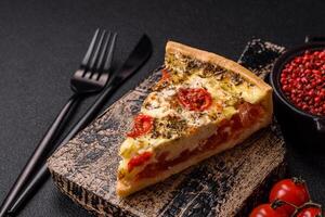 Delicious crispy quiche cut into slices with cheese, broccoli, tomatoes photo