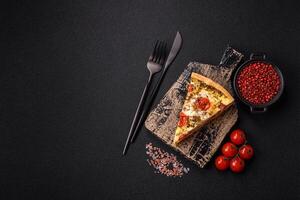 Delicious crispy quiche cut into slices with cheese, broccoli, tomatoes photo