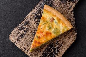 Delicious quiche with broccoli, cheese, chicken, spices and herbs photo