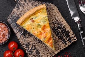 Delicious quiche with broccoli, cheese, chicken, spices and herbs photo