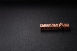 The inscription chance or change with wooden cubes on a dark concrete background photo